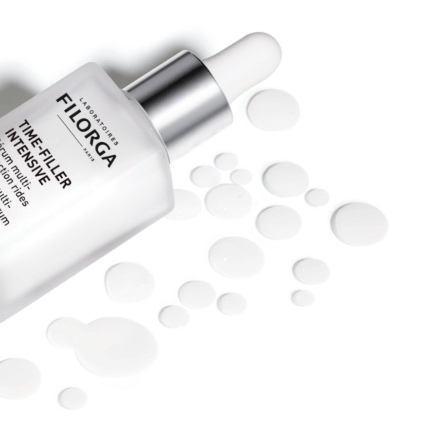 FILORGA TIME FILLER INTENSIVE SERUM with droplets all around it